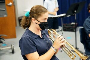 St. Timothy's student playing the trumpet in band