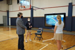 St. Timothy's students giving a presentation in the gym