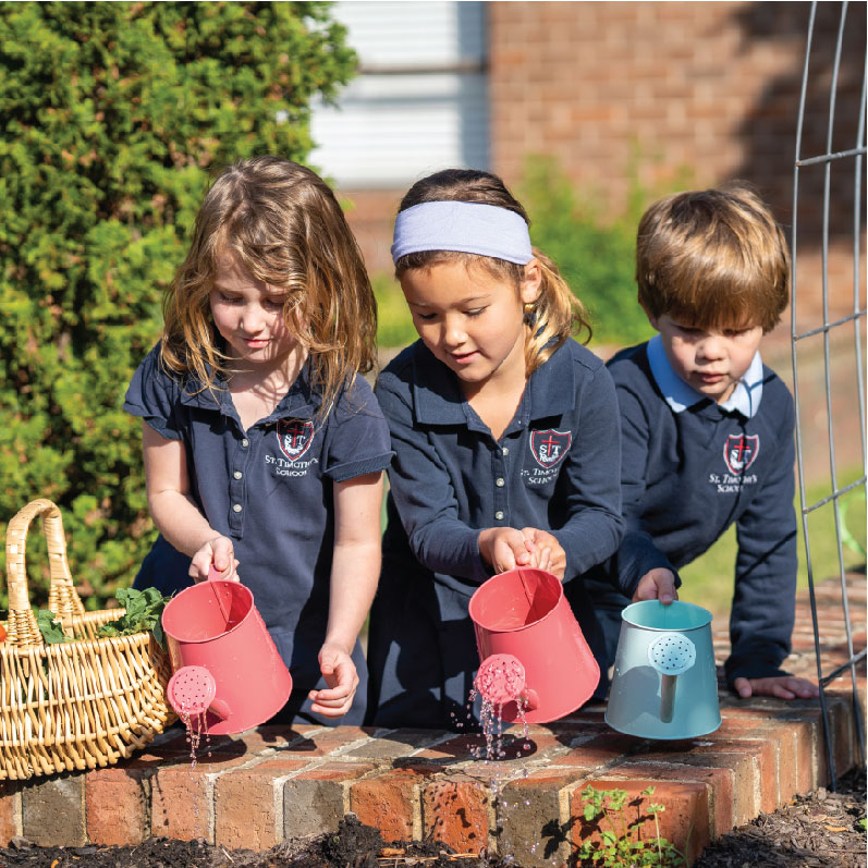 St. Timothy's pre-k and lower school students watering the campus garden