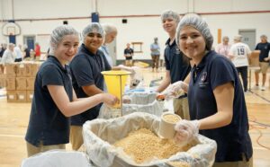St. Timothy's students packing meals for Day of Service