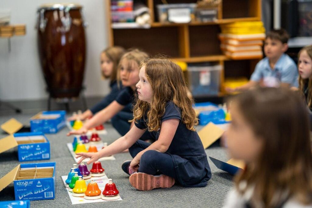 Lower school students playing bells in music class