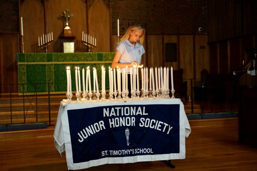 Member of the National Junior Honor Society lighting candles