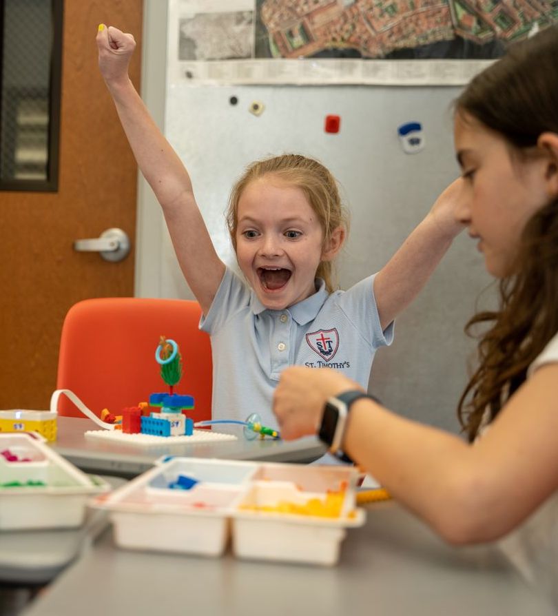 Student excited about successful experiment in class