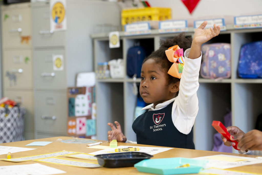 Pre-K students raising her hand in class